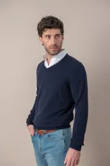 Sweater de cuello en V confeccionado en lana merino, de diseño clásico con puños y ruedo acanalados.