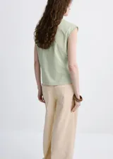 Camiseta sin mangas color verde menta, con cuello redondo y costuras decorativas pespunteadas en los hombros.