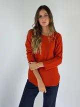 Sweater de punto color naranja, con cuello redondo y mangas largas.