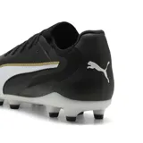 Championes de fútbol Puma King Ultimate FG/AG, color negro con franja Puma Formstrip en blanco y ribete dorado. Suela con tapones redondos y cónicos, ideal para césped natural seco y césped artificial.