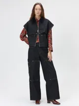 Campera de denim a rayas verticales con cuello de pana en color bordó. Presenta cierre frontal, mangas desmontables con cierre en los hombros, canesú en el pecho y bolsillos de parche cuadrados.