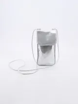 Morral porta celular de diseño minimalista en color plateado metalizado, con solapa frontal y correa larga ajustable para llevar cruzado.