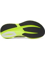 Championes de running Under Armour modelo Velociti Distance, con tecnología de amortiguación HOVR+ de longitud completa. Presentan un diseño en color blanco con detalles en amarillo neón y negro, parte superior de malla transpirable y suela de alto rendimiento.