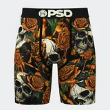 Calzoncillos bóxer de hombre con estampado de calaveras y rosas en tonos naranja y negro. Cuenta con pretina elástica negra con el logo de la marca en blanco, entrepierna de 7 pulgadas y bolsa MicroMesh transpirable.