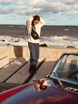 Riñonera de cuero con estampado animal print de vaca en blanco y negro, con correa regulable y cierre superior.