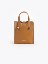 Cartera tipo tote pequeña de cuero color tostado, con doble asa superior y herrajes metálicos plateados en forma de llama en la base de las manijas. Presenta el logo de la marca estampado en la parte inferior frontal.