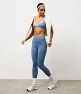 Legging deportiva de microfibra color azul, con cintura alta de diseño cruzado en forma de V y ajuste ceñido al cuerpo.