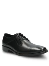 Zapato de vestir formal Hush Puppies modelo Blues, confeccionado en cuero negro con cierre de cordones. Presenta una silueta clásica con puntera redondeada y suela de goma resistente.