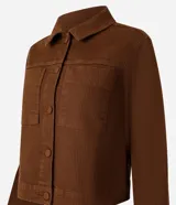 Campera marrón de sarga con textura cotelê, corte regular, cuello inglés, manga larga, abotonada y con bolsillos delanteros.