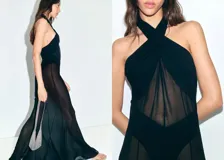 Vestido largo negro de gasa semitransparente, con cuello halter cruzado, diseño recto y forro interior.