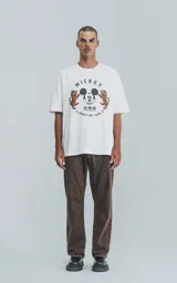 Remera de manga corta y cuello redondo con calce oversize. Presenta un estampado frontal con la cara de Mickey Mouse rodeada por dos tigres y texto alusivo.