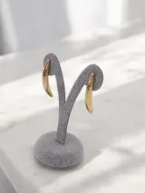 Aros de diseño minimalista con forma curva y alargada, con acabado pulido brillante.