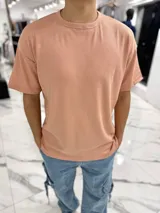 Remera oversize de tejido waffle color salmón, con cuello redondo y mangas cortas.