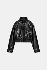 Cazadora de estilo bomber en efecto piel color negro, con cuello subido, manga larga y bajo elástico. Presenta trabillas en los hombros, bolsillos frontales con solapa y cierre de cremallera con botones a presión ocultos.