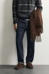 Pantalón de jean corte slim fit con efecto lavado, tiro medio, cinco bolsillos y cierre frontal con cremallera y botón.