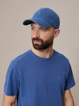 Gorro de jean azul con visera y logo bordado en naranja.