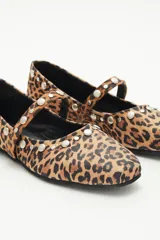 Balerina de cuero con estampado animal print de leopardo, con tira sobre el empeine y remaches de níquel de distintos tamaños. Suela con plantilla acolchonada.