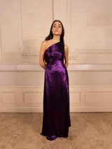 Vestido largo de fiesta color celeste metalizado, con un solo hombro y plisado en toda la prenda.