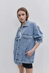 Campera de jean de silueta amplia, con cuello clásico y cierre frontal con botones. Diseño con bolsillos con solapa en el frente y bolsillos laterales, hombros caídos y terminaciones pespunteadas.