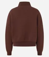 Buzo de algodón y poliéster color marrón, con cuello alto y cierre frontal parcial. Presenta diseño de hombros caídos, puños y ruedo acanalados, y estampado tipográfico frontal con la palabra Nashville.