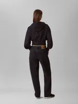 Buzo cropped con capucha y cierre frontal completo, confeccionado en punto milano. Presenta mangas largas con puños acanalados y dobladillo inferior también acanalado, ofreciendo una silueta estructurada y moderna.