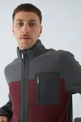 Campera polar para hombre de corte recto, con cuello alto, cierre frontal completo, bolsillos laterales con cierre y logo estampado en el pecho.