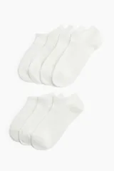 Pack de siete pares de soquetes blancos de punto fino con borde superior elástico.