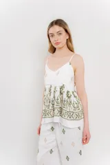 Pantalón blanco con estampado geométrico en azul y marrón, de calce relajado y caída fluida.