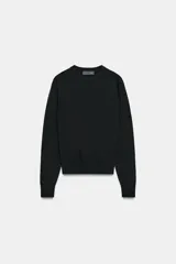 Jersey básico de cuello redondo y manga larga, confeccionado en hilatura de lana 100% con acabado de punto liso.