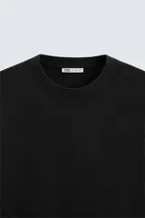 Camiseta color arena de algodón compacto, corte recto, cuello redondo y mangas cortas.