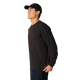 Remera Rip Curl de manga larga y textura tipo waffle, color negro, con cuello redondo y diseño de corte clásico.