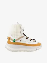 Bota hasta el tobillo color blanco con detalles en marrón y suela track.