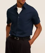 Camisa de manga corta con cuello inglés y cierre frontal de botones, confeccionada en mezcla de bambú y viscosa.
