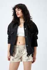 Short color crema con estampado abstracto en tonos grises, de tiro bajo y cintura elástica.