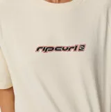 Remera de manga corta Rip Curl modelo Sunset Beach Raglan Boxy, color beige con calce holgado y estampado frontal con el logo de la marca en tonos oscuros y rosados.