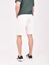 Bermuda de jean color gris lavado, tiro medio y corte recto, con largo por encima de la rodilla.