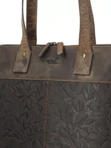 Cartera tipo tote bag marca RKF, confeccionada en cuero 100% natural color marrón con diseño grabado de hojas y ramas en relieve. Cuenta con doble asa de hombro del mismo material, cierre superior y un discreto logotipo grabado en la parte frontal.