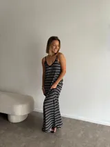 Vestido largo de jersey, color negro con rayas horizontales blancas, corte recto y tirantes finos.