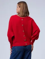 Buzo marca Cupio de tejido acanalado color azul. Tiene mangas largas estilo dolman y aplique de botones en la espalda.