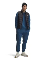 Pantalón de jogging Under Armour, color azul, con cintura elástica, puños acanalados en los tobillos y logo de la marca en la pierna derecha.