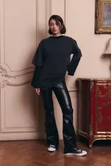 Pantalon de tiro alto confeccionado en ecocuero, con diseño semi oxford y cierre metálico lateral. Presenta un recorte horizontal sobre la rodilla.