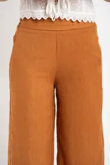 Pantalón de lino color tostado, de corte recto y tiro medio.