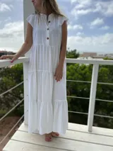 Vestido largo celeste de corte holgado, con cuello mao, mangas cortas y botones frontales.