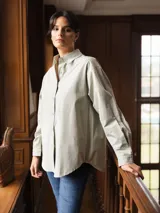 Camisa de algodón color blanco, de corte clásico y manga larga con cierre frontal de botones.
