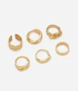 Kit de seis anillos metálicos de diseño orgánico con formas irregulares, texturas variadas y acabado pulido en color dorado.
