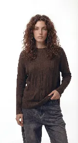 Sweater de punto con textura de ochos verticales, cuello redondo, mangas largas con puños acanalados y silueta relajada.