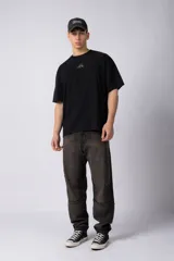 Remera de corte oversize confeccionada en algodón pesado con textura de micropanal. Presenta un diseño minimalista con un pequeño bordado lineal de un sol en el centro del pecho.