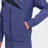 Campera deportiva Reebok azul con detalles en negro, cierre frontal y logo bordado en el pecho.