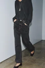 Pantalón de jean celeste de tiro medio, corte ancho y terminación con dobladillo.