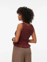Blusa sin mangas color bordó con cuello redondo, calce regular y detalle de smock en todo el cuerpo, con terminación con volados.